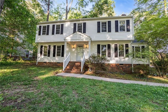 colonial home featuring a front yard, crawl space, and a chimney