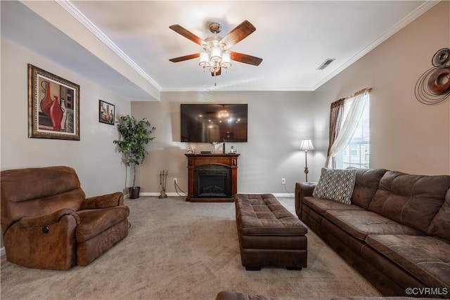 carpeted living area featuring ceiling fan, ornamental molding, a fireplace, and baseboards