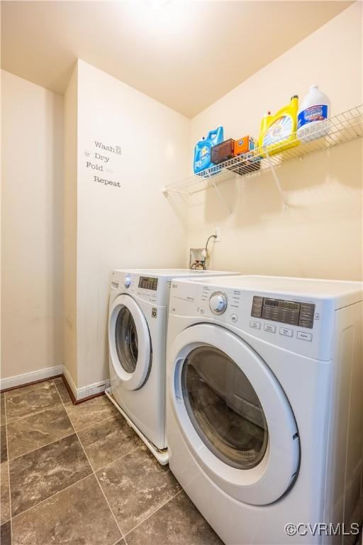 laundry room with separate washer and dryer and baseboards