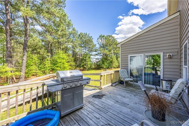 wooden deck with a grill