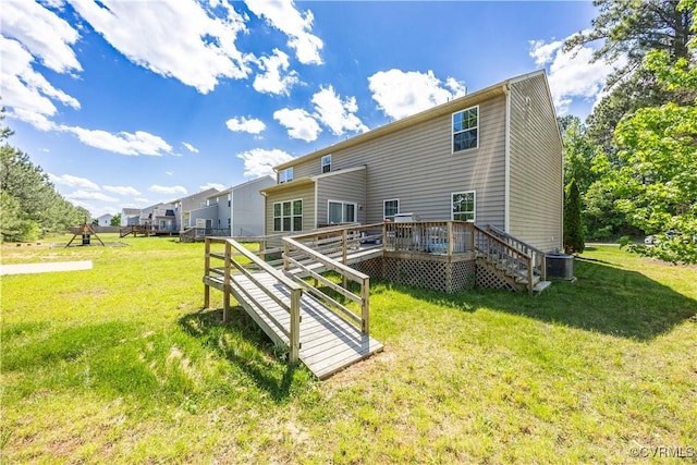 rear view of house featuring central AC unit, a deck, and a lawn