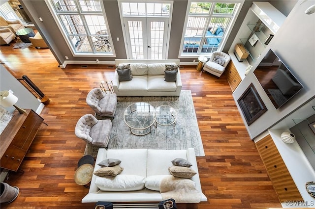 living room with baseboards, french doors, and wood finished floors