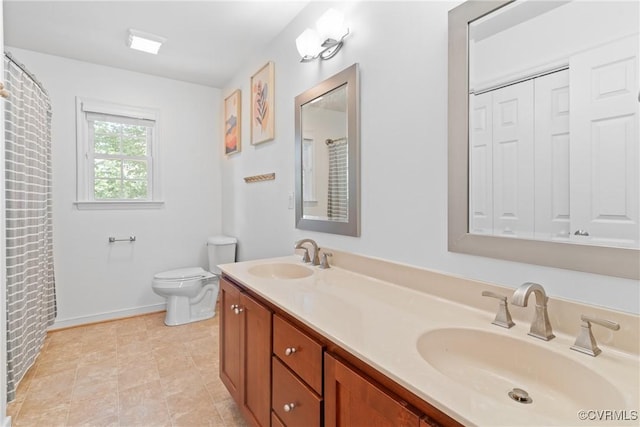 full bathroom with toilet, double vanity, and baseboards