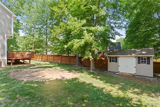 view of yard featuring a deck, a storage unit, and an outdoor structure