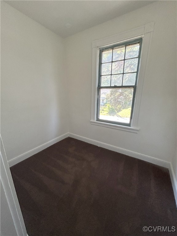 2307 Wright Ave, Richmond, VA 23224 - spare room featuring baseboards and dark colored carpet