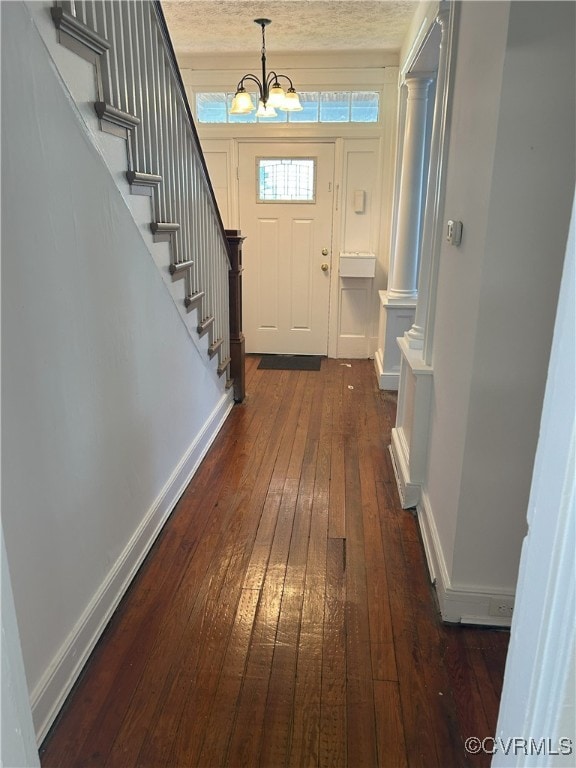 2307 Wright Ave, Richmond, VA 23224 - entryway with dark wood finished floors, a chandelier, and stairway