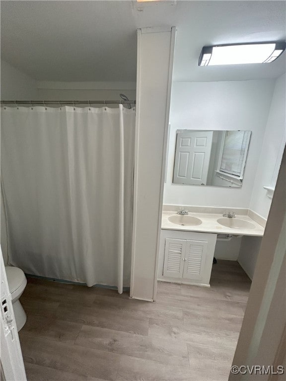 2307 Wright Ave, Richmond, VA 23224 - full bath featuring double vanity and wood finished floors