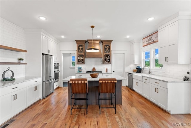 3307 Colston Ct, Powhatan, VA 23139 - kitchen with a breakfast bar area, a sink, premium range hood, stainless steel appliances, and tasteful backsplash