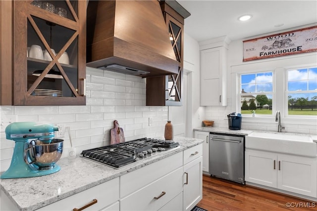 3307 Colston Ct, Powhatan, VA 23139 - kitchen featuring a sink, stainless steel appliances, tasteful backsplash, wall chimney range hood, and glass insert cabinets