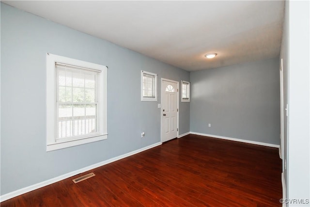 entryway featuring baseboards and wood finished floors