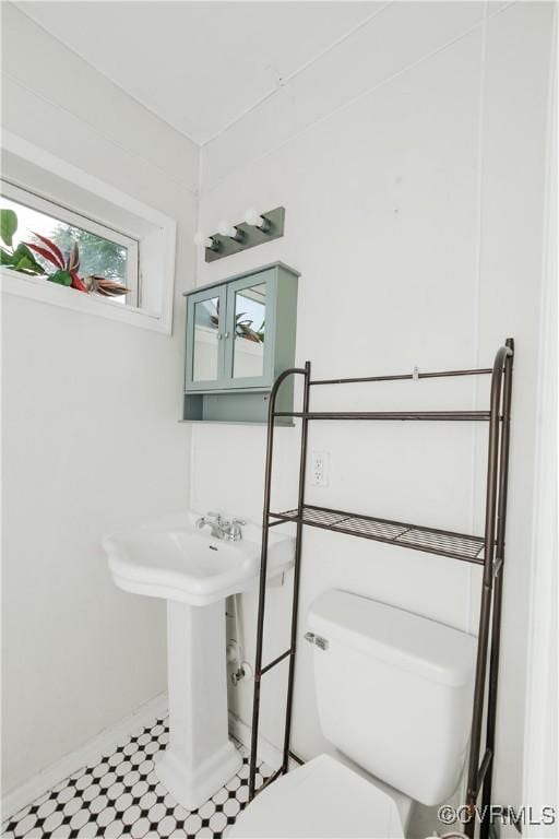 bathroom with plenty of natural light and toilet