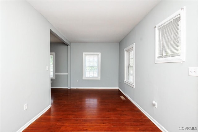 empty room with wood finished floors and baseboards