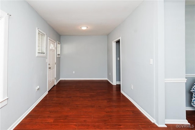 hall featuring wood finished floors and baseboards