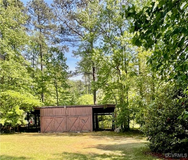 209 Pineview Dr, Hartfield, VA 23071 - view of grassy yard featuring an outdoor structure and an outbuilding