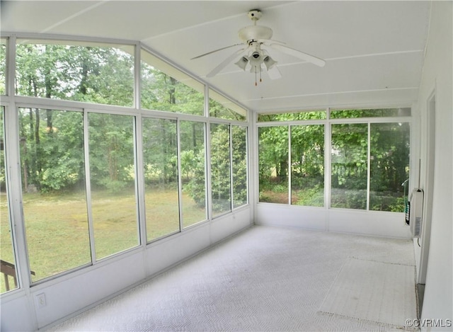 unfurnished sunroom with ceiling fan