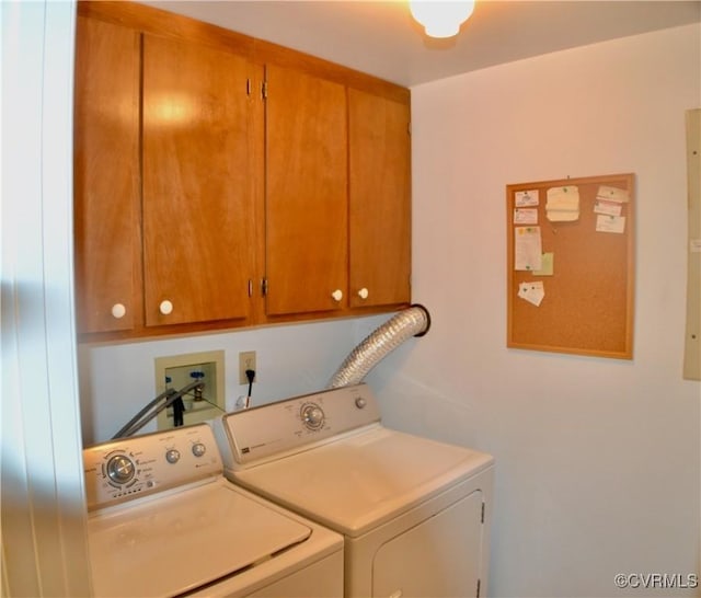 washroom featuring separate washer and dryer and cabinet space