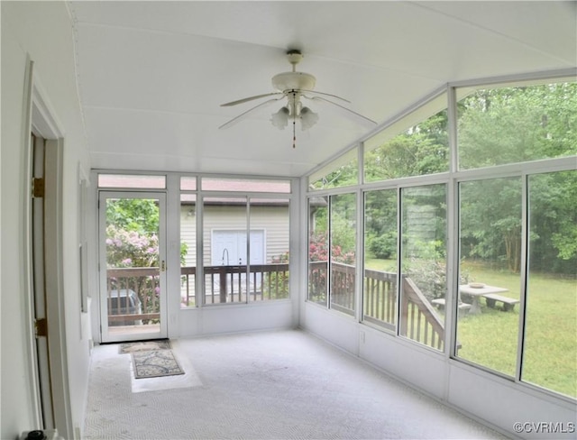 unfurnished sunroom with a ceiling fan