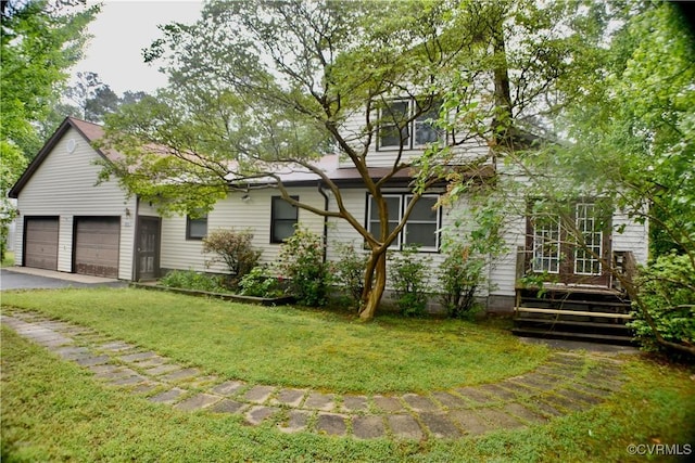 view of front facade featuring aphalt driveway, a garage, and a front lawn