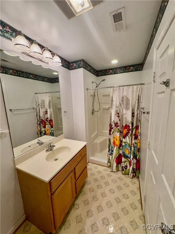 full bathroom featuring vanity and curtained shower