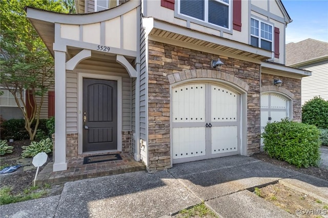 5529 Frog Pond Ln, Virginia Beach, VA 23455 - entrance to property featuring stone siding, an attached garage, and driveway