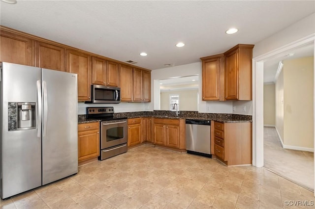 5529 Frog Pond Ln, Virginia Beach, VA 23455 - kitchen featuring recessed lighting, visible vents, dark stone countertops, brown cabinets, and appliances with stainless steel finishes