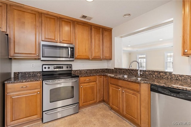 5529 Frog Pond Ln, Virginia Beach, VA 23455 - kitchen featuring a sink, brown cabinets, visible vents, and appliances with stainless steel finishes