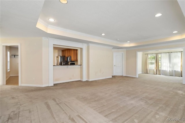 5529 Frog Pond Ln, Virginia Beach, VA 23455 - unfurnished living room featuring a tray ceiling, light colored carpet, ornamental molding, and recessed lighting