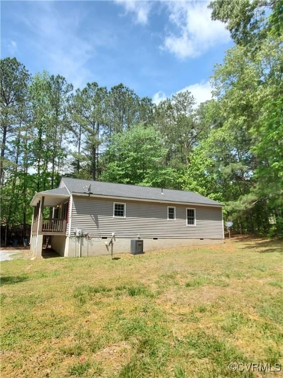 349 Whispering Pine Ln, Bumpass, VA 23024 - back of property with central AC, a yard, crawl space, and view of wooded area