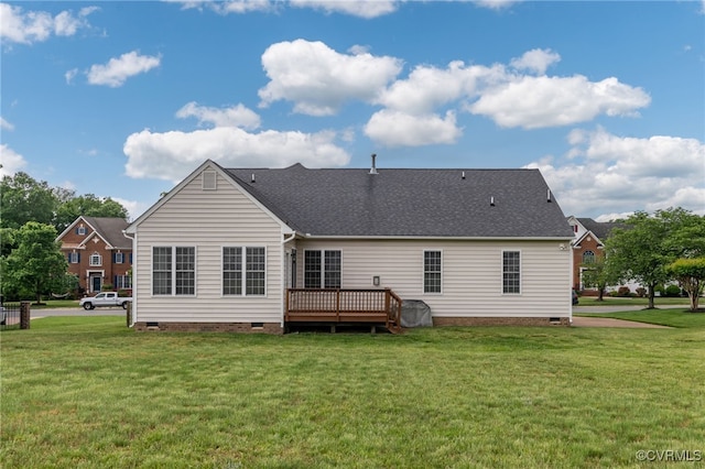 rear view of property with crawl space, a yard, a deck, and a shingled roof