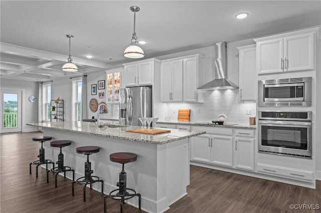 6 Flatwater Row Unit B, Henrico, VA 23231 - kitchen featuring appliances with stainless steel finishes, wall chimney exhaust hood, recessed lighting, a kitchen breakfast bar, and white cabinetry