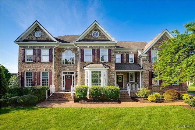 colonial-style house featuring a front lawn and brick siding