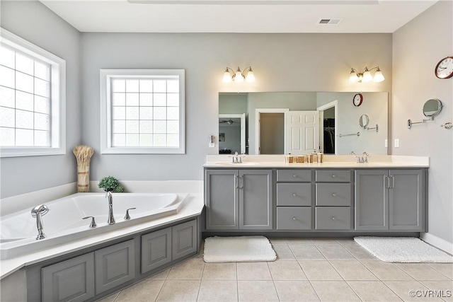 full bathroom with tile patterned flooring, double vanity, and a bath