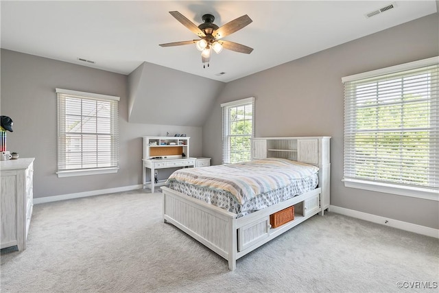 carpeted bedroom with baseboards, vaulted ceiling, and a ceiling fan