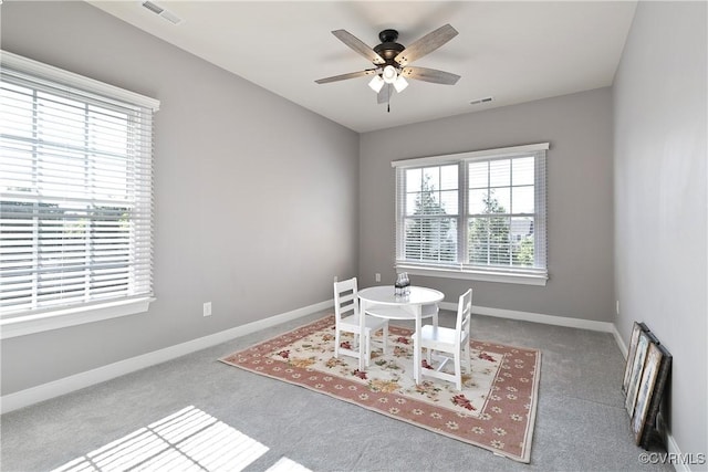 dining room featuring carpet, ceiling fan, and baseboards