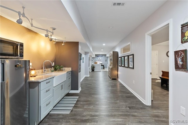 hallway with a sink, dark wood-type flooring, baseboards, and recessed lighting