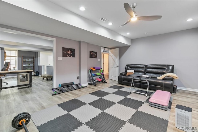 exercise area featuring wood finished floors, baseboards, ceiling fan, and recessed lighting