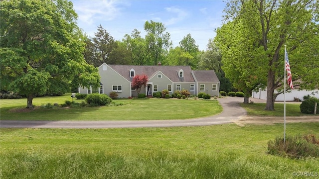 33356 Richmond Tpke, Hanover, VA 23069 - cape cod-style house featuring a front yard, view of wooded area, and a chimney