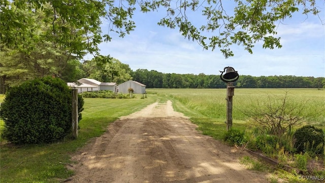 view of dirt / gravel driveway with a rural view