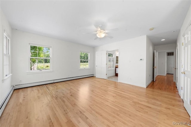 unfurnished living room featuring baseboard heating, light wood-style flooring, a ceiling fan, and baseboards