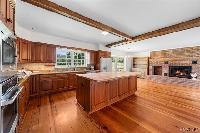 33356 Richmond Tpke, Hanover, VA 23069 - kitchen featuring stainless steel appliances, a center island, a fireplace, dark wood-style flooring, and a chandelier