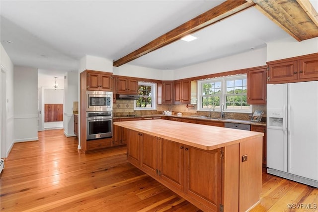 33356 Richmond Tpke, Hanover, VA 23069 - kitchen with stainless steel appliances, butcher block counters, beam ceiling, a kitchen island, and decorative backsplash