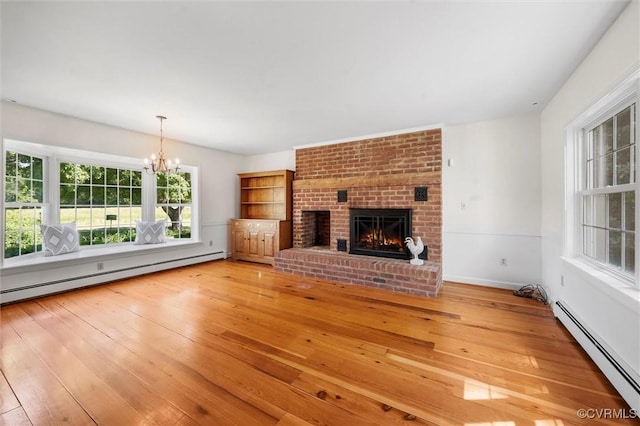 33356 Richmond Tpke, Hanover, VA 23069 - unfurnished living room with a baseboard radiator, a baseboard heating unit, a chandelier, and light wood-style flooring