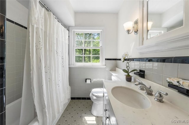 33356 Richmond Tpke, Hanover, VA 23069 - full bath with tile walls, toilet, vanity, shower / tub combo, and a wainscoted wall