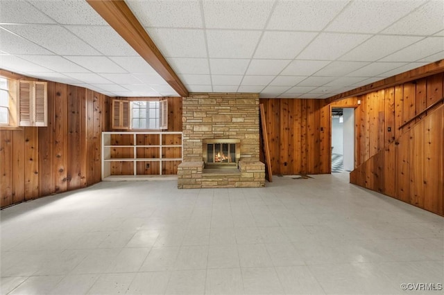 33356 Richmond Tpke, Hanover, VA 23069 - below grade area featuring wooden walls, a stone fireplace, a paneled ceiling, and tile patterned floors