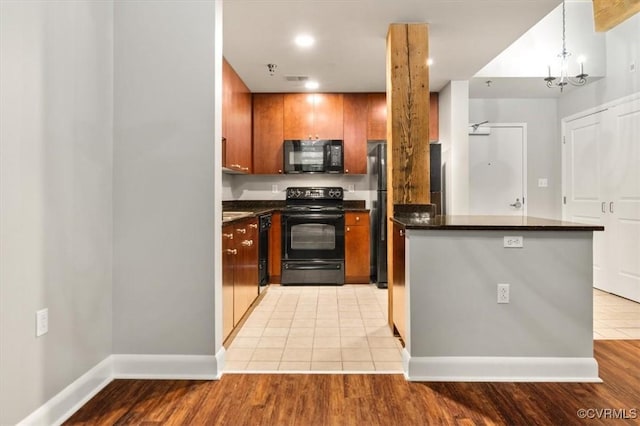 251 Rocketts Way Unit 204, Henrico, VA 23231 - kitchen with black appliances, dark countertops, baseboards, brown cabinetry, and recessed lighting