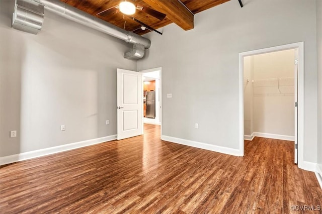 251 Rocketts Way Unit 204, Henrico, VA 23231 - unfurnished bedroom featuring wooden ceiling, a spacious closet, a towering ceiling, wood finished floors, and beamed ceiling