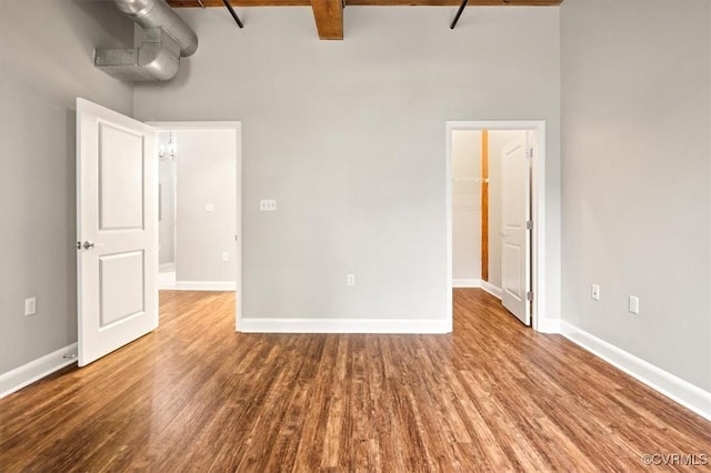 251 Rocketts Way Unit 204, Henrico, VA 23231 - unfurnished room featuring a towering ceiling, wood finished floors, beamed ceiling, and baseboards