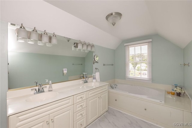 full bathroom with lofted ceiling, marble finish floor, a garden tub, and a sink