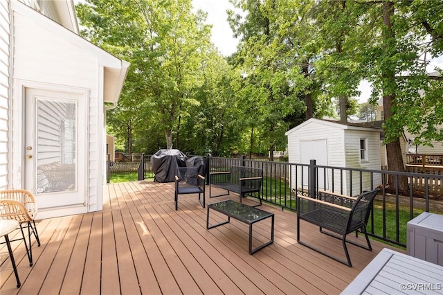 wooden terrace featuring a storage shed and an outdoor structure