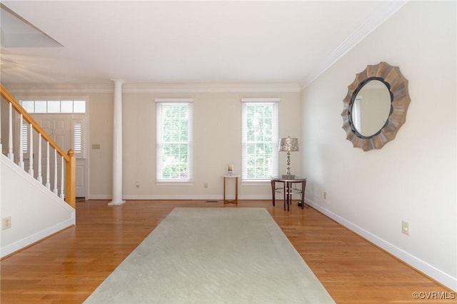 entryway featuring stairway, ornamental molding, baseboards, and light wood-style floors